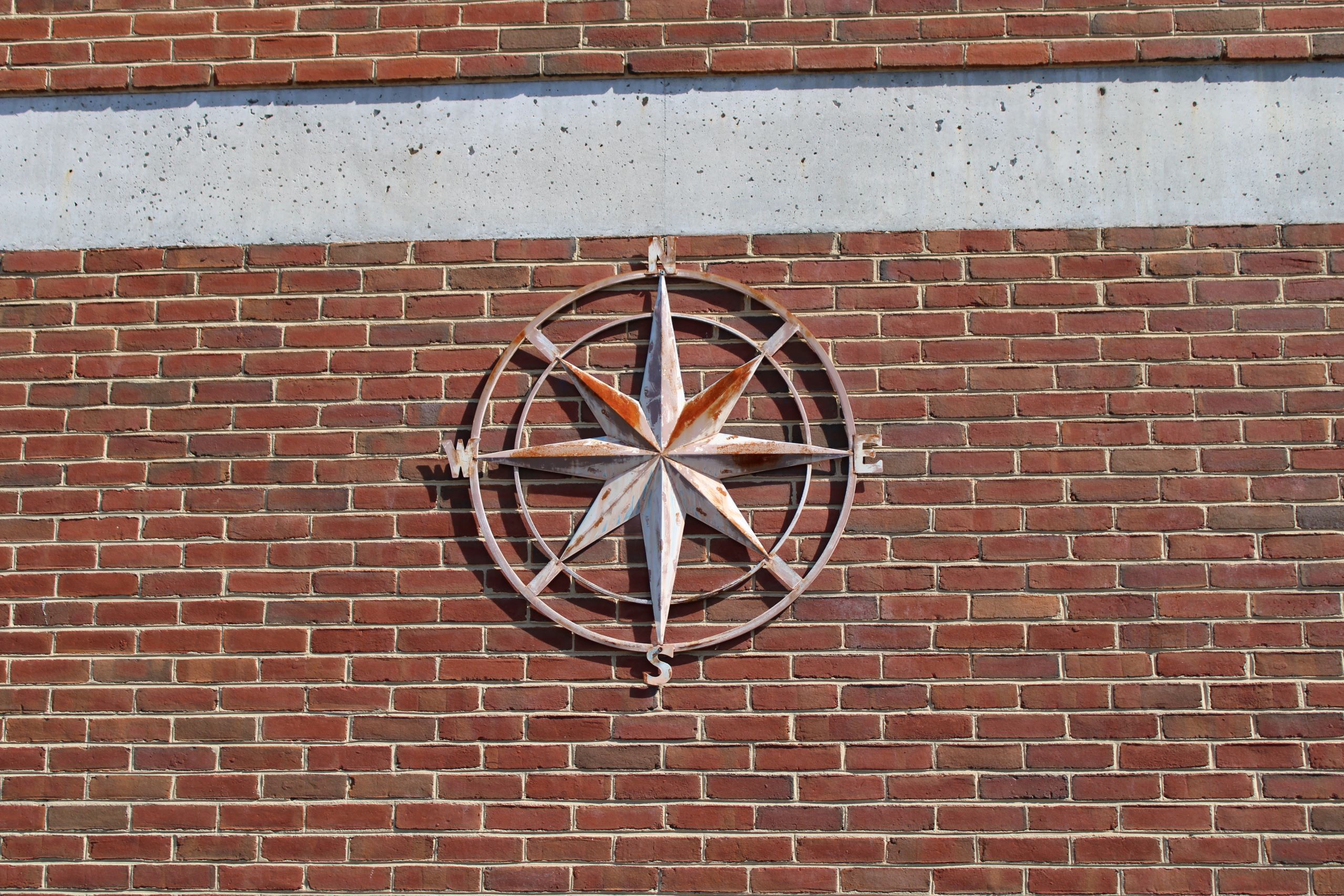 Compass art hanging outside